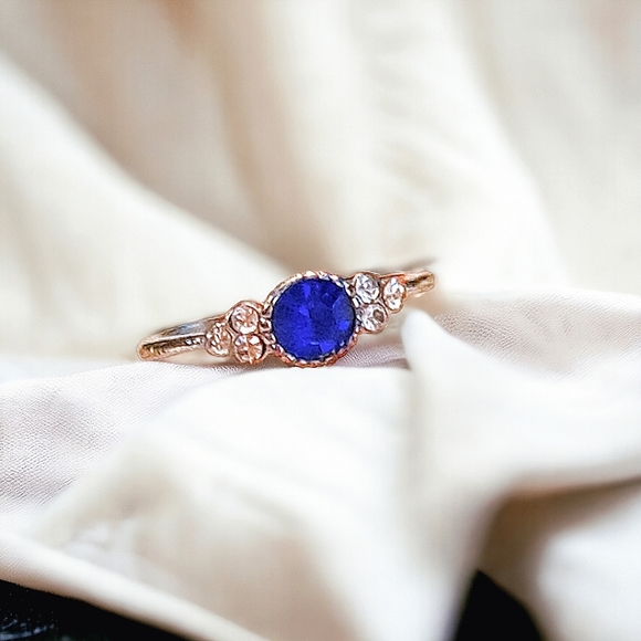 Jewelry - Beautiful ring with blue center stone and 3 CZ on each side. Size 5